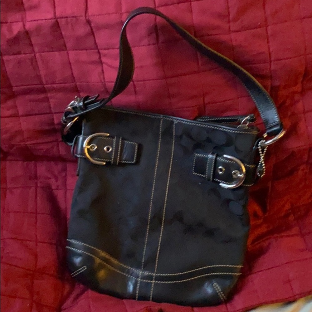 Black coach small purse with short strap .